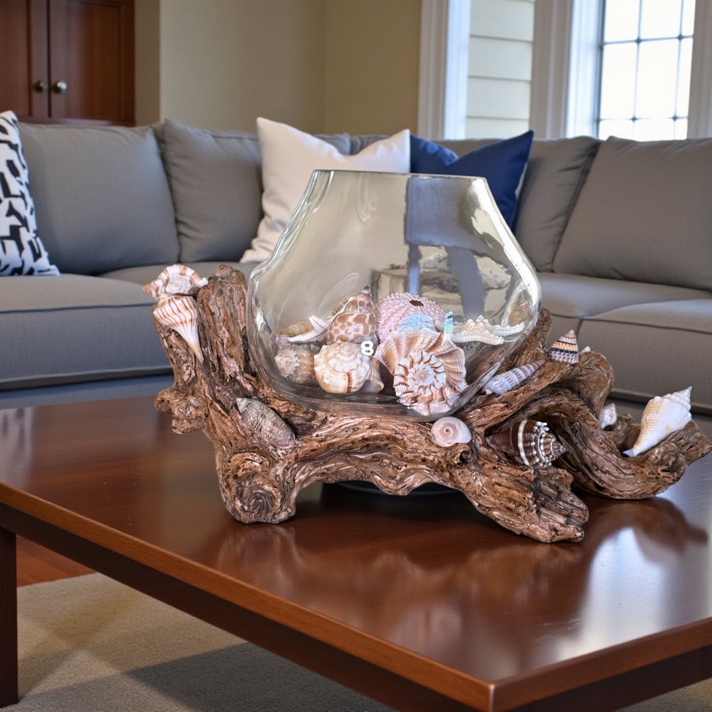 Glass vase with seashells on driftwood