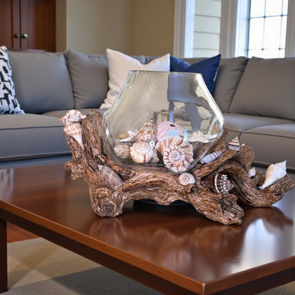 Glass vase with seashells on driftwood