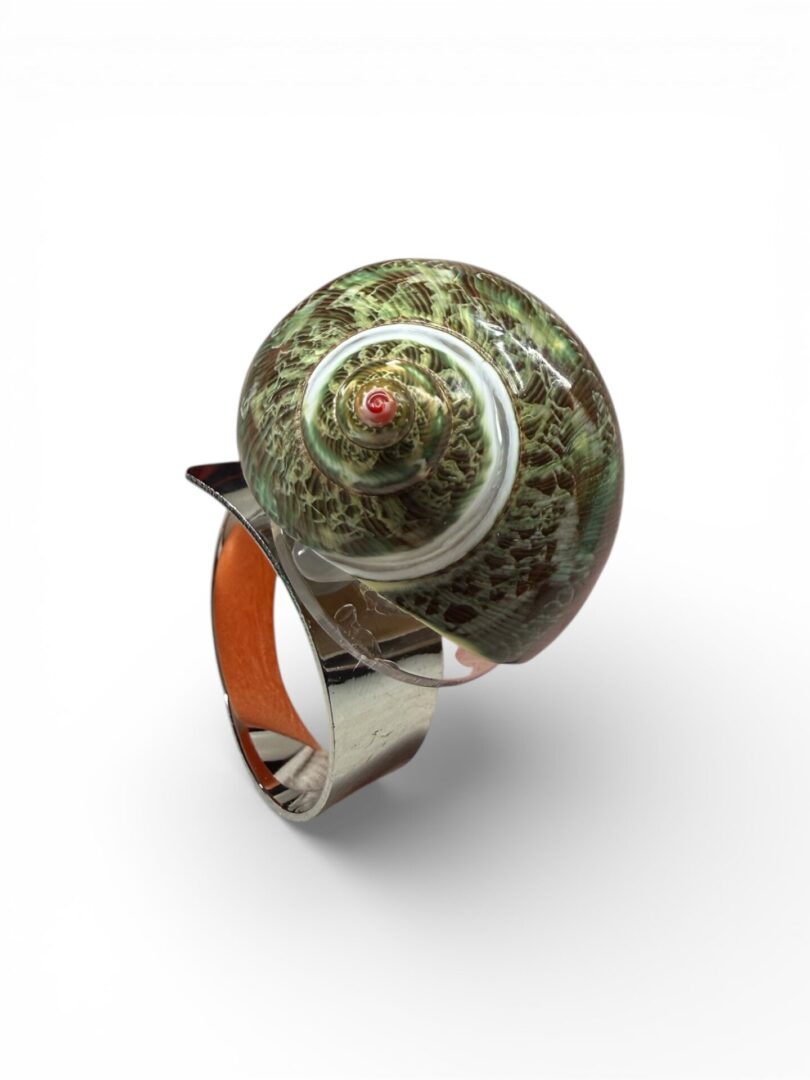 Artistic ring featuring a detailed globe design on top.